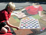 Nolan plays checkers with Nolan