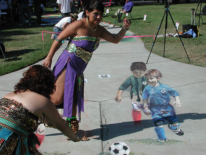 The Aztec dancers try to kick and catch the ball