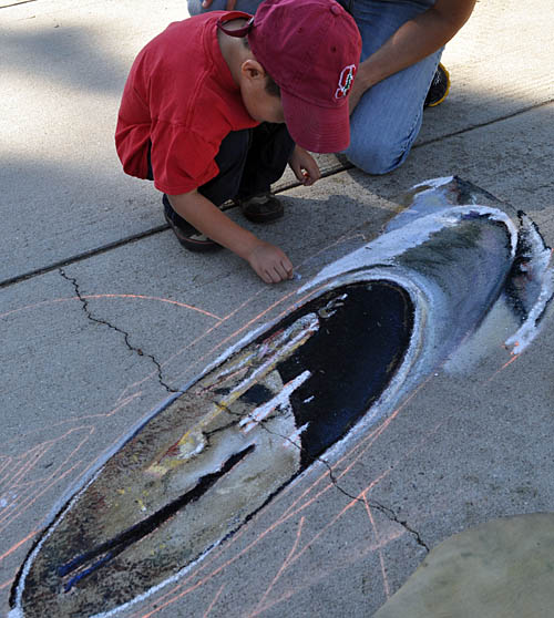Wayne teaches a child to paint